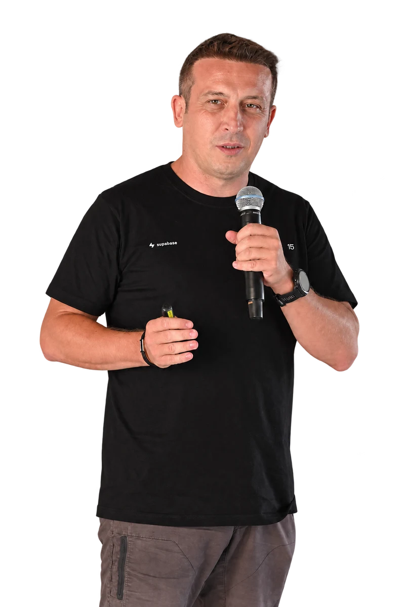 A speaker holding a microphone and clicker at the June Hack A Ton